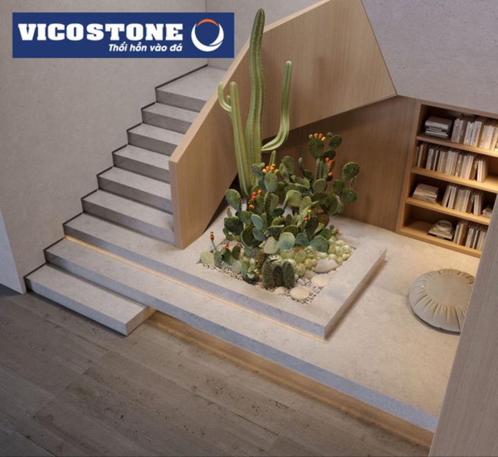 Tận dụng gầm cầu thang ốp đá VICOSTONE Concreto BQ8860 lấy cảm hứng từ bề mặt giả xi măng (concrete looking) hiệu ứng vân mốc xám ghi, trắng trên bề mặt xám sáng làm góc đọc sách giúp không gian trở nên tiện dụng hơn