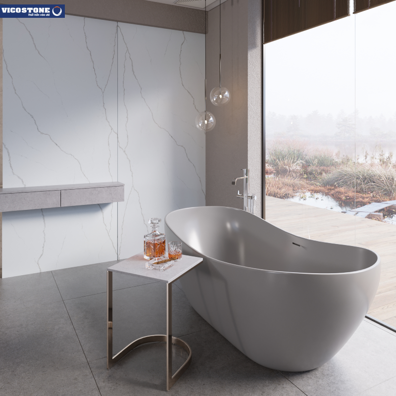 Bồn tắm đá nhân tạo VICOSTONE Alessandria BQ8915 hình thuyền cách điệu hòa cùng sắc xám thanh nhã, trắng tinh khôi của đá ốp làm nên một bức tranh đầy nên thơ nơi phòng tắm